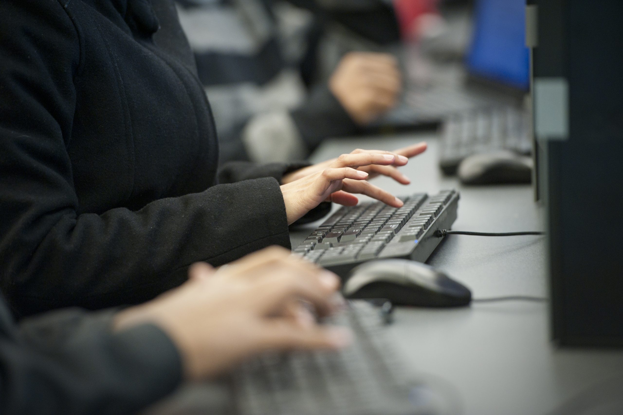 Anonymous person typing on a keyboard